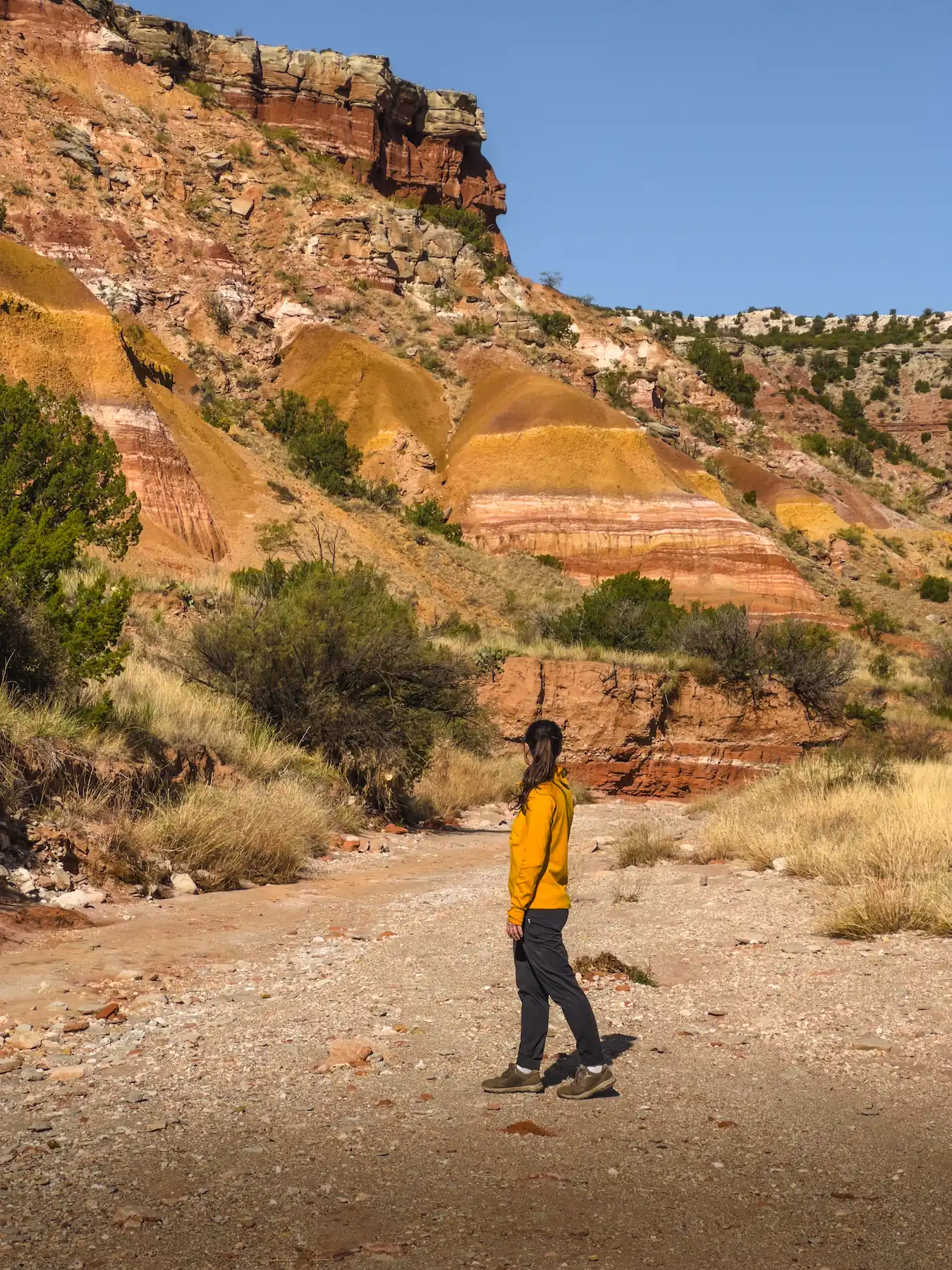 Woman looking at rock formations in palo duro canyon amarillo texas