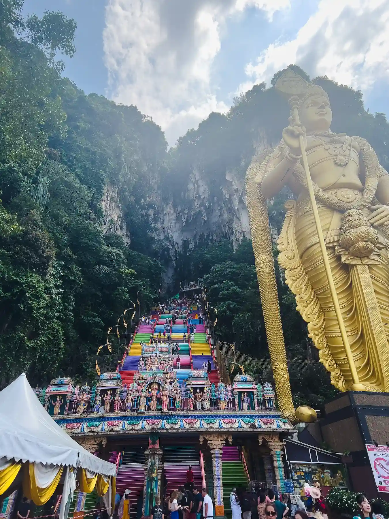 Multicolored steps and giant Hindu statue leading up to entrance of Batu Caves in Kuala Lumpur